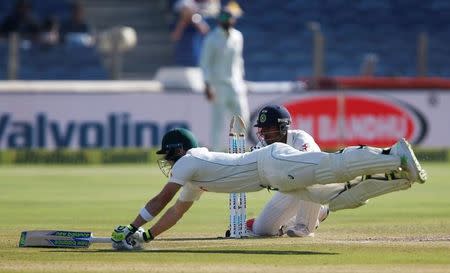 Cricket - India v Australia - First Test cricket match - Maharashtra Cricket Association Stadium, Pune, India - 25/02/17. Australia's captain Steve Smith dives to the crease during a run out attempt. REUTERS/Danish Siddiqui