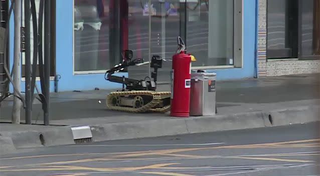 The bomb squad has deployed a robot to inspect the package. Source: 7 News