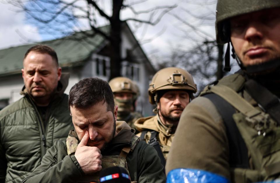 President Volodymyr Zelensky (2nd from left) walks in the town of Bucha, just northwest of the Ukrainian capital Kyiv on April 4, 2022. Zelensky said Russian leadership was responsible for civilian killings in Bucha, outside Kyiv, where bodies were found lying in the street after the town was retaken by the Ukrainian army.