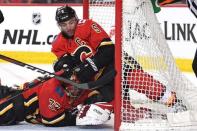 Mar 19, 2019; Calgary, Alberta, CAN; Calgary Flames defenseman Mark Giordano (5) and goalie David Rittich (33) makes a save against from the Columbus Blue Jackets in the second period at Scotiabank Saddledome. Mandatory Credit: Candice Ward-USA TODAY Sports