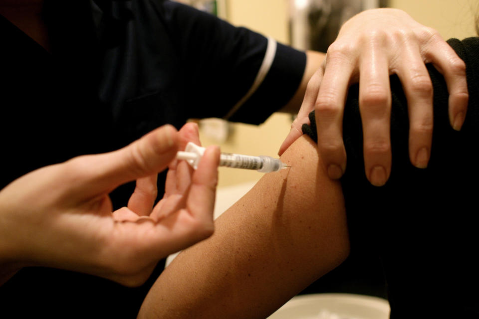 nurse injecting vaccine