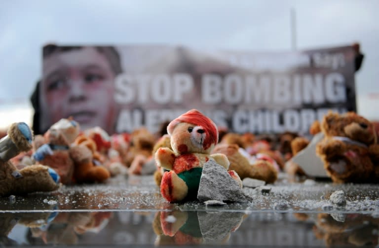 Red-smeared teddy bears are used by campaigning group Avaaz to protest against the bombing of the Syrian city of Aleppo on October 19, 2016 in Berlin