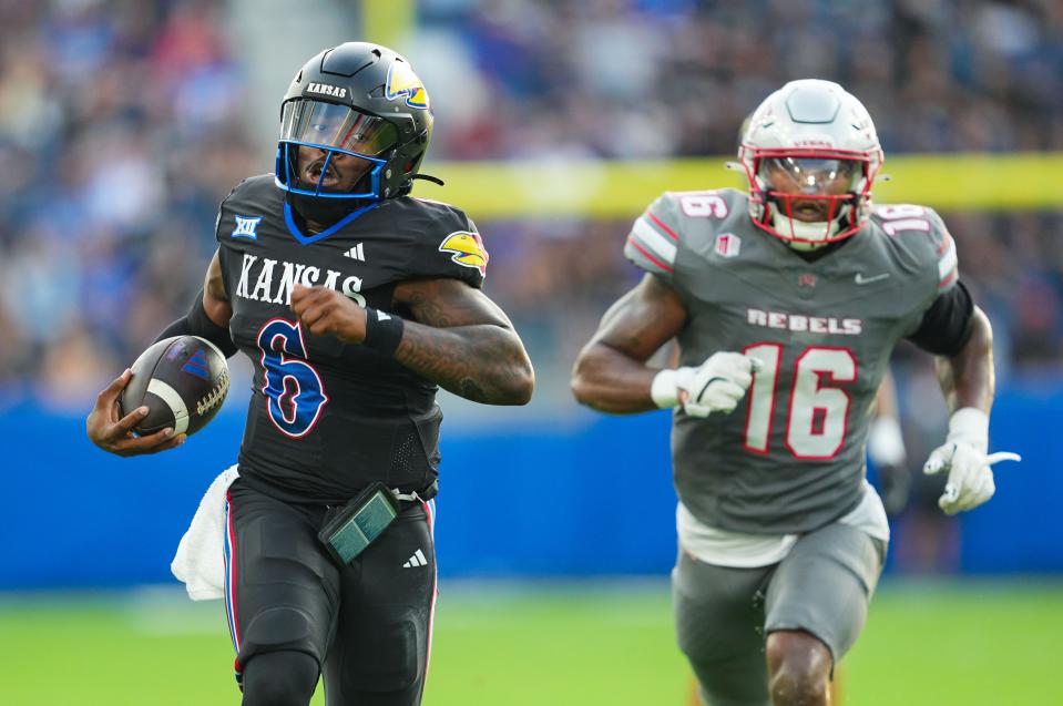 Kansas football quarterback Jalon Daniels (6) runs for a touchdown Friday during a game against UNLV at Children's Mercy Park in Kansas City, Kansas.