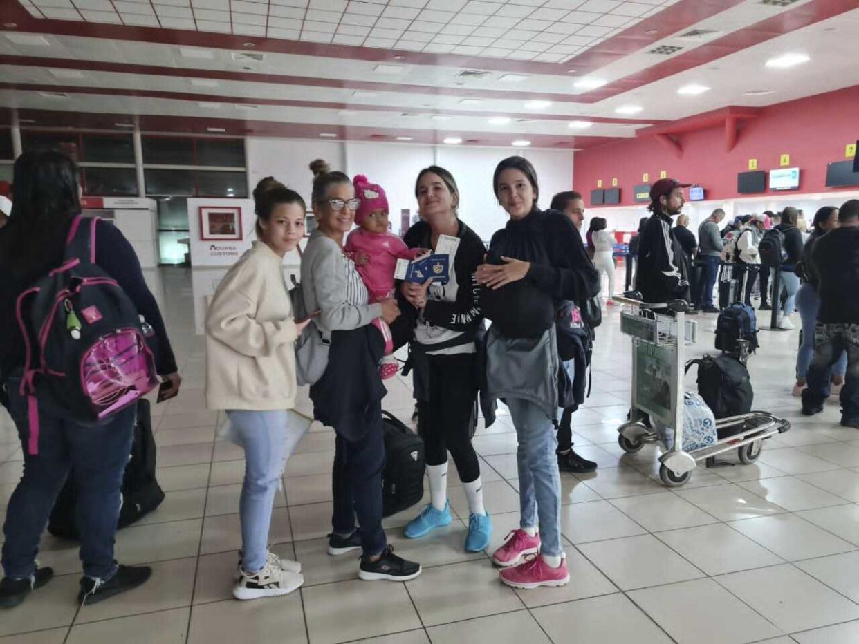 This photo, courtesy of Mayte Isabel Dolado Hernandez, shows Marialys Gonzalez Lopez holding her granddaughter Madisson, second from left, alongside Marialy's daughters Merlyn and Melanie, second from right and right, at the Jose Marti International Airport in Havana, Cuba, Tuesday, Dec. 13, 2022. The woman at left is the sisters' cousin Adilen Montano. (Maite Isabel Dorado via AP)