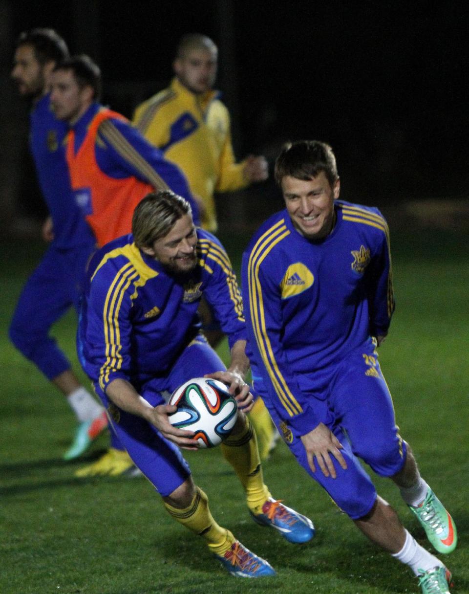 Ukraine's Anatoliy Tymoschuk, left, and Ruslan Rotan attend a training session in Ayia Napa resort on the southeast of Cyprus, Tuesday March 4, 2014. The Ukrainians will play the United States in a friendly match on Wednesday in Cyprus, after the match was moved from Kharkiv in Ukraine to Larnaca in Cyprus for security reasons. (AP Photo/Petros Karadjias)