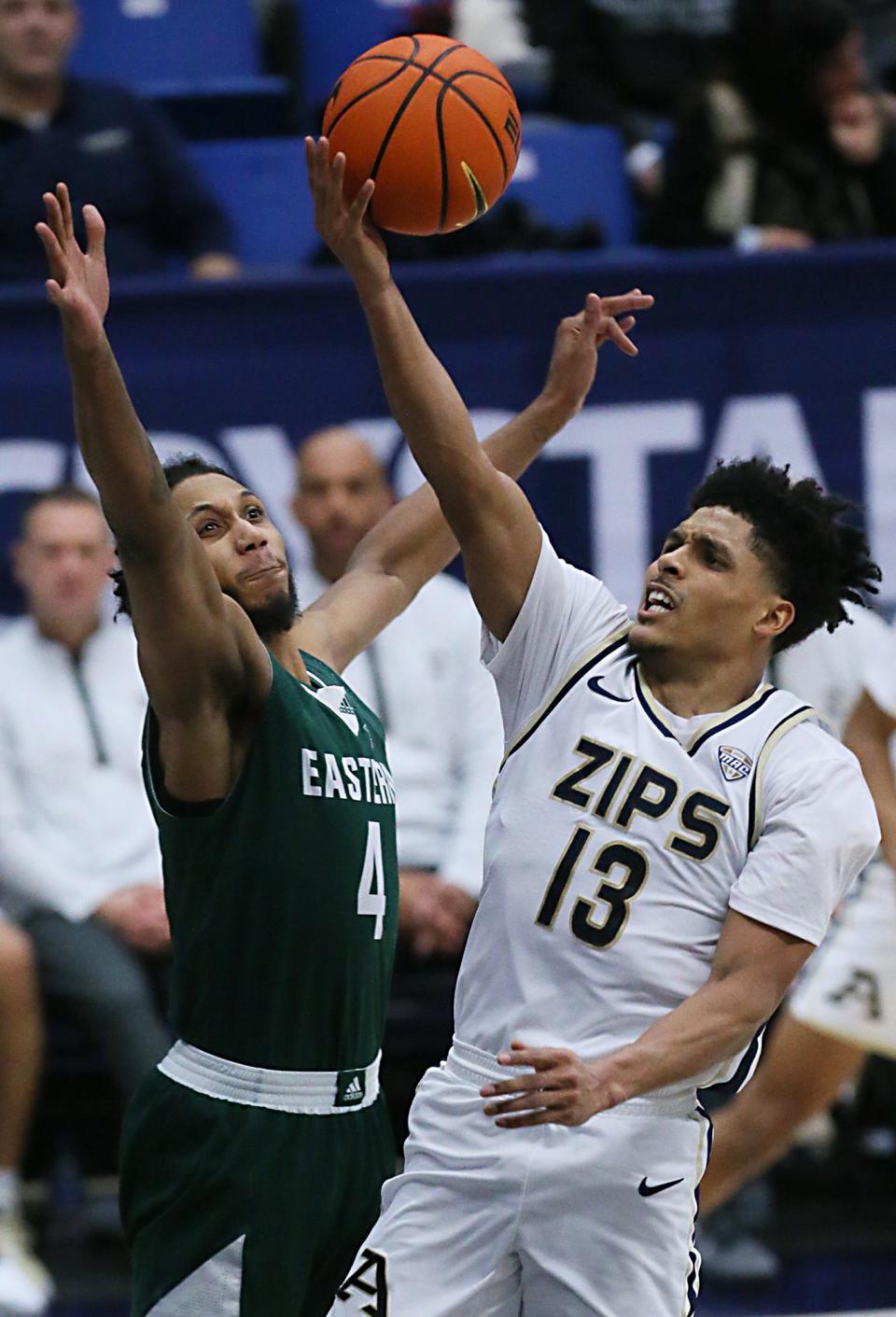 Eastern Michgan's Jalin Billingsley guards Akron's Xavier Castaneda as he shoots during their MAC game at the University of Akron's James A. Rhodes Arena on Friday. The Zips beat the Eagles 104 to 67.