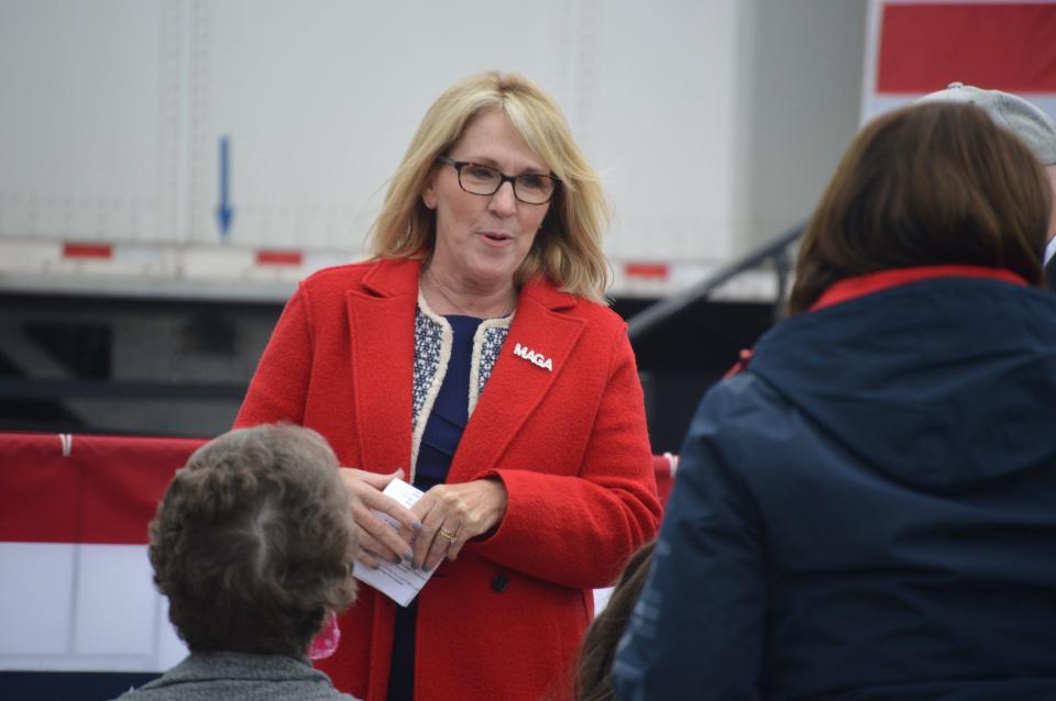 Laura Cox, chairwoman of the Michigan Republican Party, speaks with constituents prior to Vice President Mike Pence's arrival on Oct. 14, 2020, at a "Make America Great Again," rally in Grand Rapids.