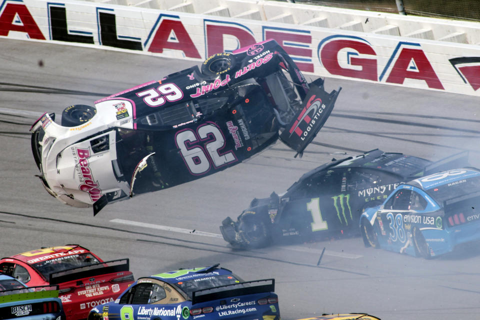 Brendan Gaughan (62) flips in Turn 3 during a NASCAR Cup Series auto race at Talladega Superspeedway, Monday, Oct 14, 2019, in Talladega, Ala. (AP Photo/Greg McWilliams)