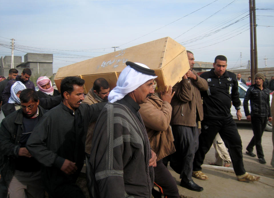 Mourners carry the coffin of Ahmed Abdel-Razzaq, who was killed in a mortar attack, before his burial at the cemetery in Fallujah, Iraq, Tuesday, Jan. 14, 2014. Violence has been on the rise in Iraq recently as security forces and allied Sunni tribesmen in Anbar province battle al-Qaida fighters over the control of two key cities there. (AP Photo)