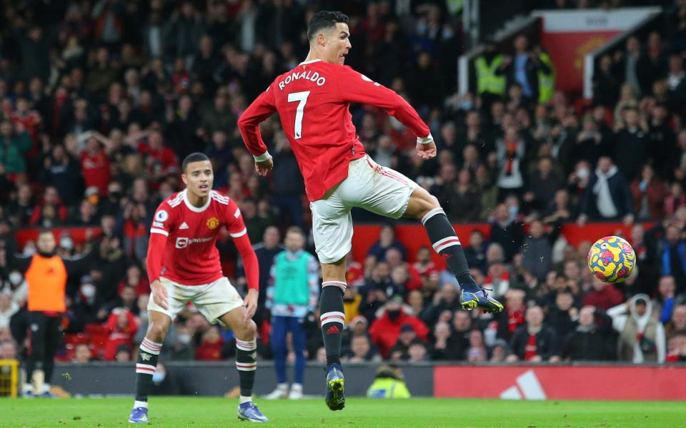 Cristiano Ronaldo of Manchester United scores their third goal during the Premier League match between Manchester United and Burnley - James Gill - Danehouse/Getty Images