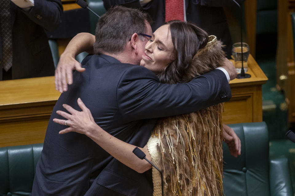 Jacinda Ardern, right, is hugged by Finance Minister Grant Robertson after Ardern made her final speech to New Zealand's Parliament in Wellington, on Wednesday, April 5, 2023, after her five-year tenure as prime minister. A global icon of the left and an inspiration to women around the world, Ardern in January stepped down as prime minister, saying “I know what this job takes, and I know that I no longer have enough in the tank to do it justice. It is that simple." (Mark Mitchell/New Zealand Herald via AP)