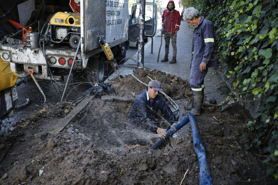 A worker of the Water Leak Detection and Repair Brigade works to repair a leak in the neighborhood of Coyoacán of Mexico City, Monday, March 18, 2024. As the election approaches, a worsening water crisis is making it harder for the presidential candidates to ignore Mexico’s climate threats. (AP Photo/Eduardo Verdugo)