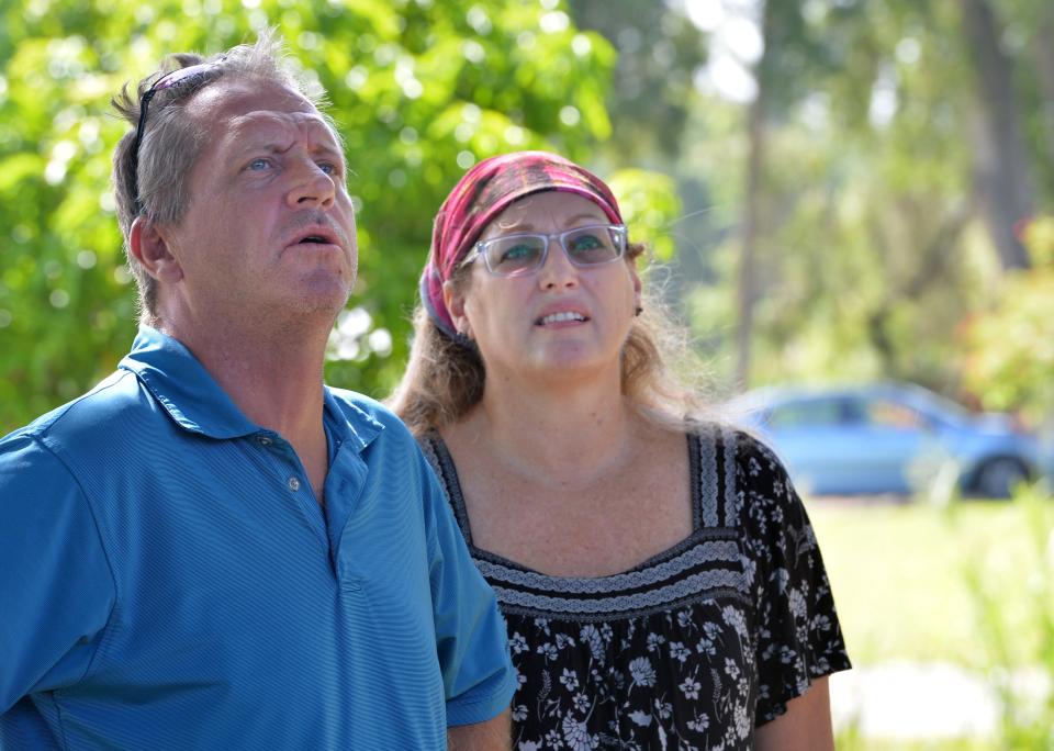 Air Force veteran Richard Eaton, and his finace, Robin Oneill, watch as roofers from Mighty Dog Roofing remove old shingles and tar paper from their home in South Venice on Tuesday, July 26, 2022.  Eaton is receiving a new roof as part of the Owens Corning Roof Deployment Project. Mighty Dog Roofing Southwest Florida, an Owens Corning platinum roofing contractor, is working on the project. Eaton was selected through partnership with Purple Heart Homes. 