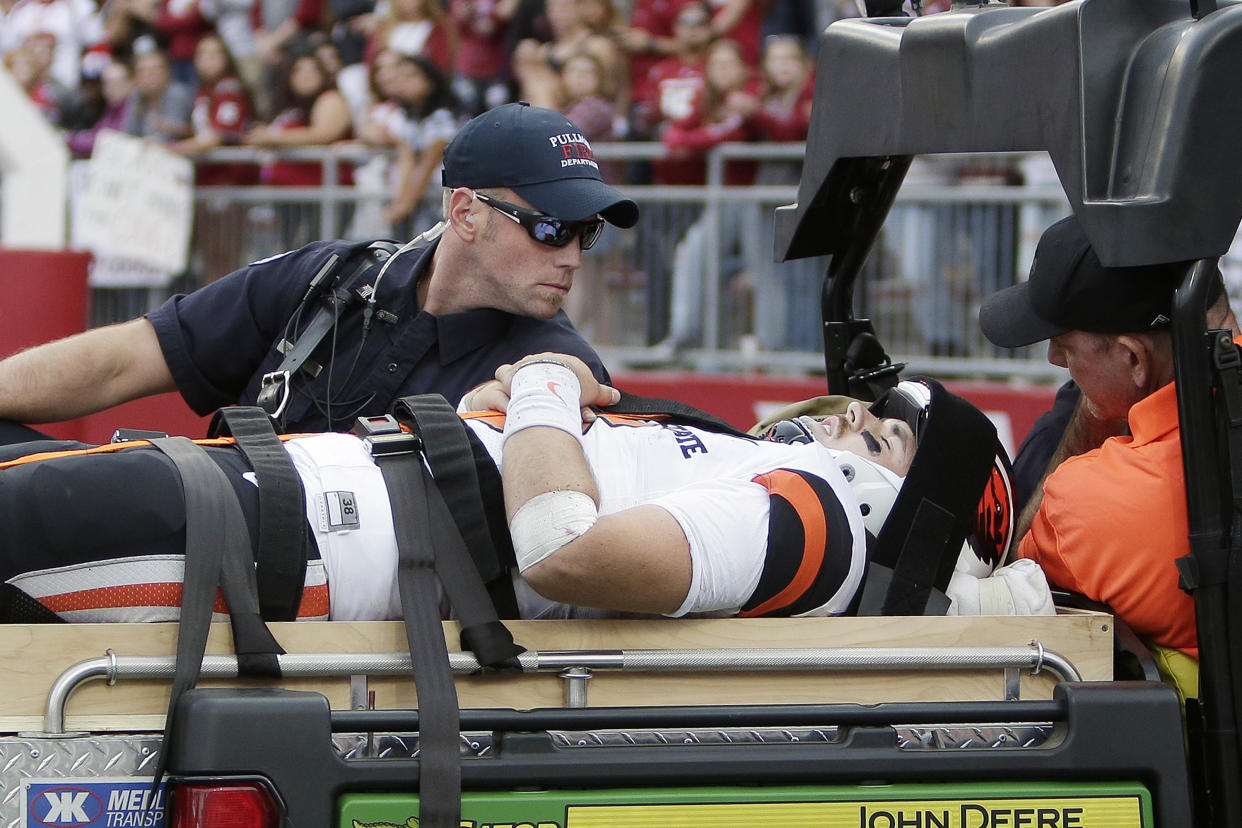 Oregon State quarterback Jake Luton is carted off the field after suffering an injury against Washington State. (AP Photo/Young Kwak)