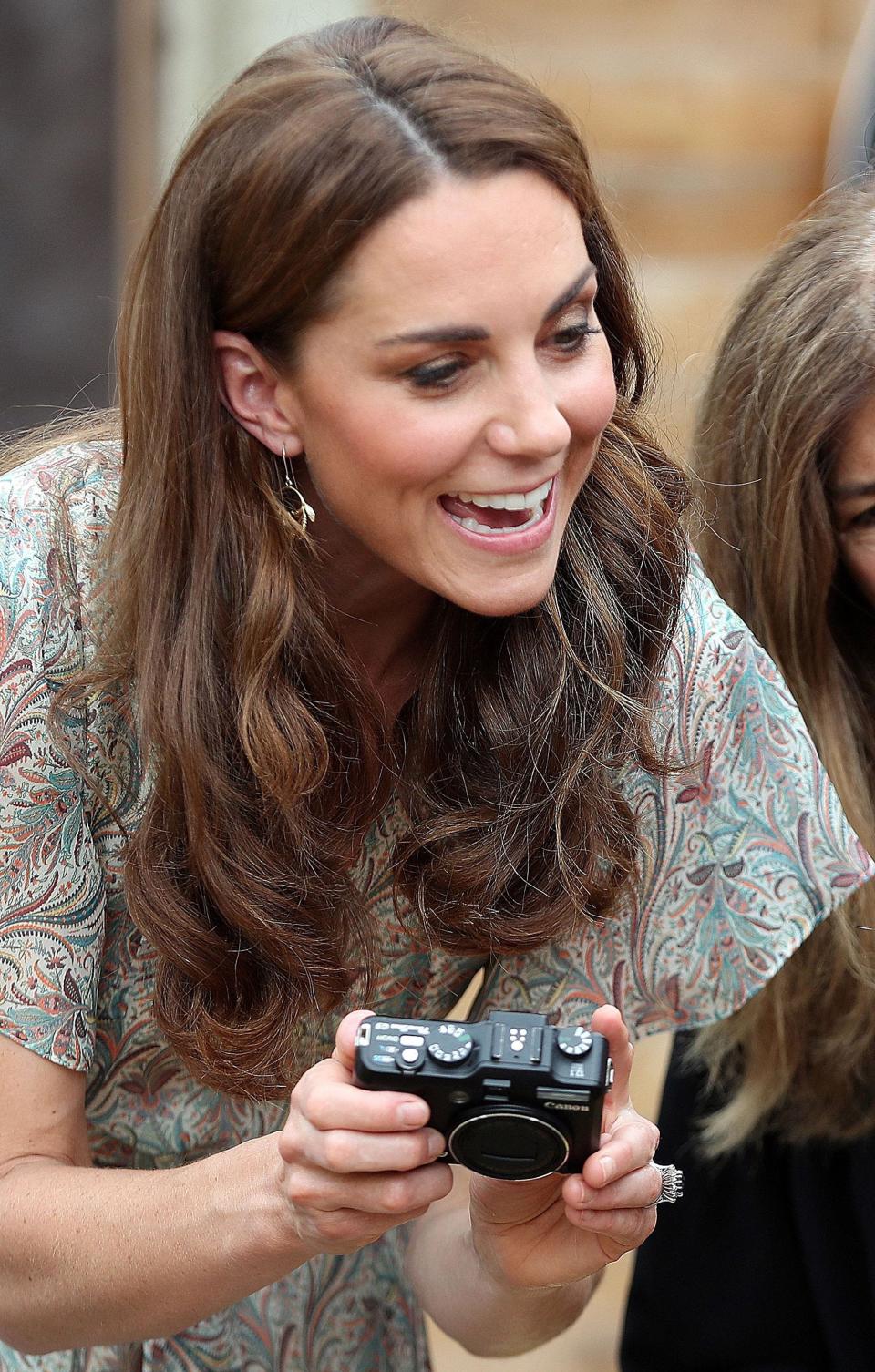 Kate Middleton holds a camera