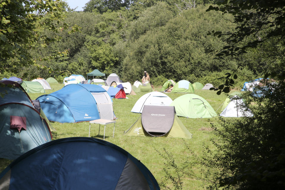 Activists set up tents in a camping site Wednesday, Aug. 21, 2019 in Urrugne, southwestern France. Protesters are setting up camp in towns near the Spanish border to prepare actions during the Aug. 24-26 gathering of major world democracies. (AP Photo/Bob Edme)