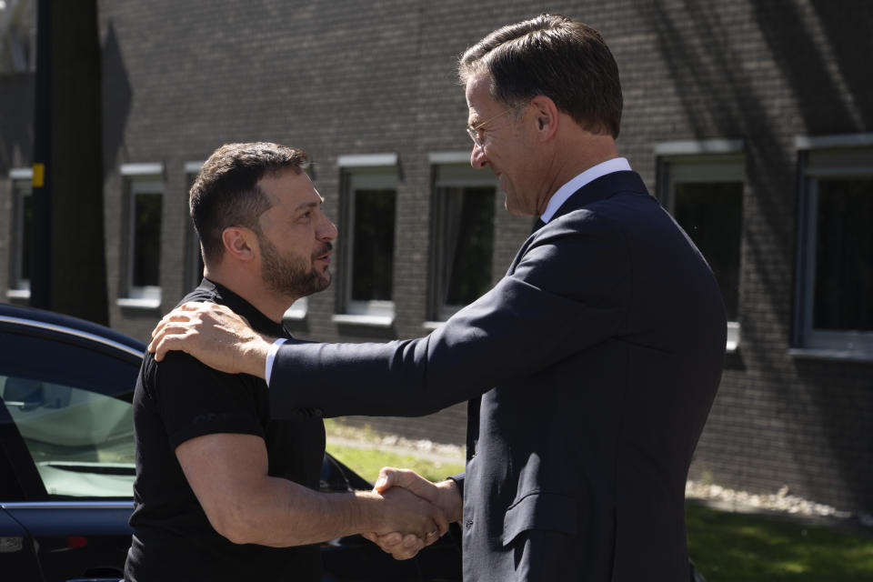 FILE - Ukrainian President Volodymyr Zelenskyy, left, is greeted by Dutch caretaker Prime Minister Mark Rutte in Eindhoven, Netherlands, Sunday, Aug. 20, 2023. Over the course of more than a dozen years at the top of Dutch politics, Mark Rutte got to know a thing or two about finding consensus among fractious coalition partners. Now he's going to bring the experience of leading four Dutch multiparty governments to the international stage as NATO's new secretary general. (AP Photo/Peter Dejong, File)