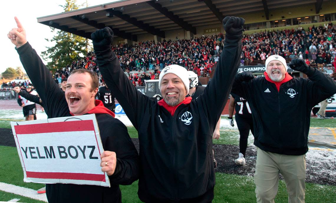 Yelm head coach Jason Ronquillo (center) and his assistants celebrate as the clock expires on the Tornados’ 20-13 victory over the Eastside Catholic Crusaders in the 3A football state championship game at Sparks Stadium in Puyallup, Washington, on Saturday, Dec. 3, 2022.