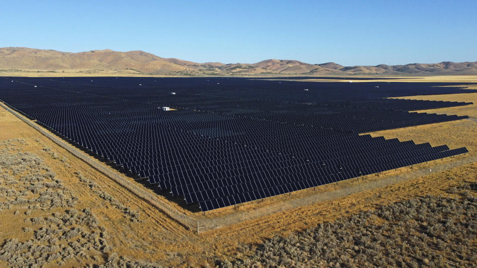 File - A solar farm spans open land as seen on Tuesday, Aug. 9, 2022, in Mona, Utah. Across Europe companies are weighing up the U.S. Inflation Reduction Act's $375 billion in benefits for renewable industries against the European Union's fragmented response. (AP Photo/Rick Bowmer, File)
