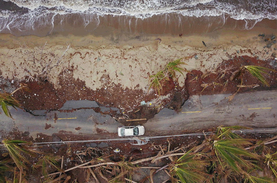 A car drives on a damaged road in the aftermath of Hurricane Maria in Humacao on Oct. 2, 2017, and then the same road on March 17, 2018.