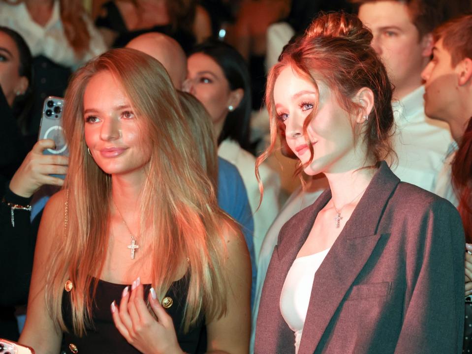 Elizaveta Peskova and a friend in front of a crowd in January 2022