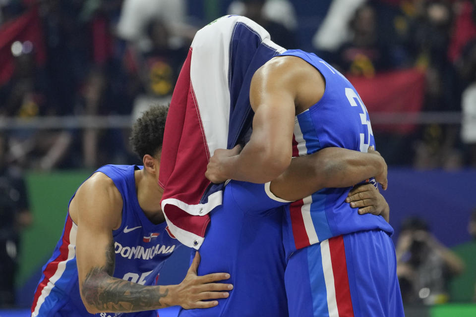 Dominican Republic team celebrates after winning against Angola during their Basketball World Cup group A match at the Araneta Coliseum, Manila, Philippines on Tuesday, Aug. 29, 2023. (AP Photo/Aaron Favila)