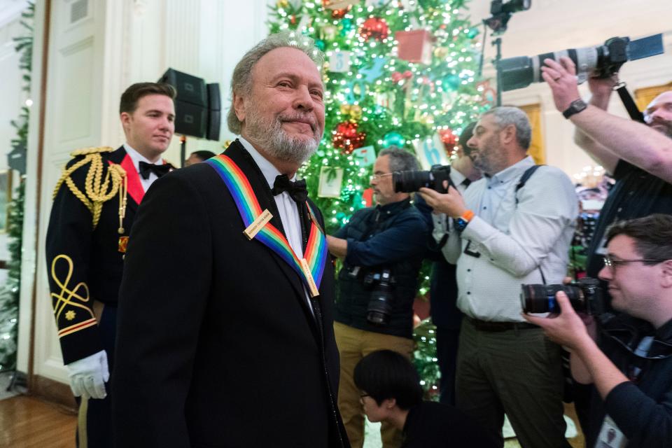 2023 Kennedy Center honoree Billy Crystal walks in the East Room during a ceremony for the Kennedy Center honorees at the White House.