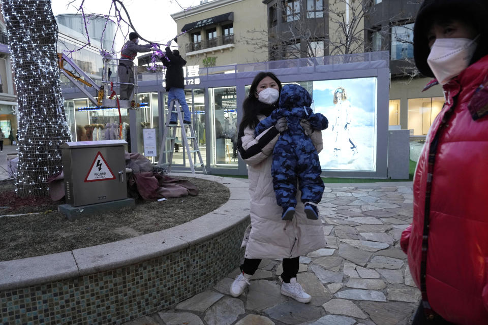 Shoppers return to a mall with shops re-opening for business as restrictions are eased in Beijing, Saturday, Dec. 3, 2022. Chinese authorities on Saturday announced a further easing of COVID-19 curbs with major cities such as Shenzhen and Beijing no longer requiring negative tests to take public transport. (AP Photo/Ng Han Guan)