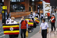 FILE - In this June 20, 2021, file photo, members of Uganda's Olympic team prepare to leave for Osaka, at Narita Airport in Narita, near Tokyo. With tens of thousands of visitors coming to a country that is only 13.8 percent fully vaccinated, gaps in border controls have emerged, highlighted by the discovery of infections among the newly arrived team from Uganda, with positive tests for the highly contagious delta variant.(Sadayuki Goto/Kyodo News via AP, File)