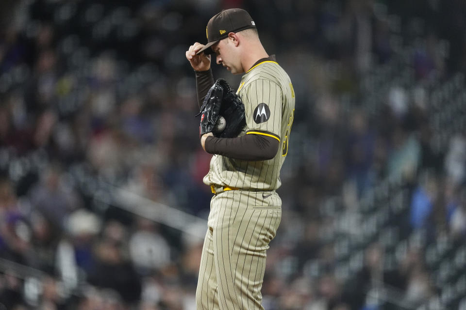 San Diego Padres starting pitcher Michael King adjusts his cap after giving up a grand slam to Colorado Rockies' Brendan Rodgers during the fourth inning of a baseball game Tuesday, April 23, 2024, in Denver. (AP Photo/David Zalubowski)