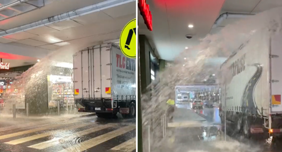 The driver is seen pulling into Westfield Knox in Melbourne's east having struck a pipe with water gushing down. 