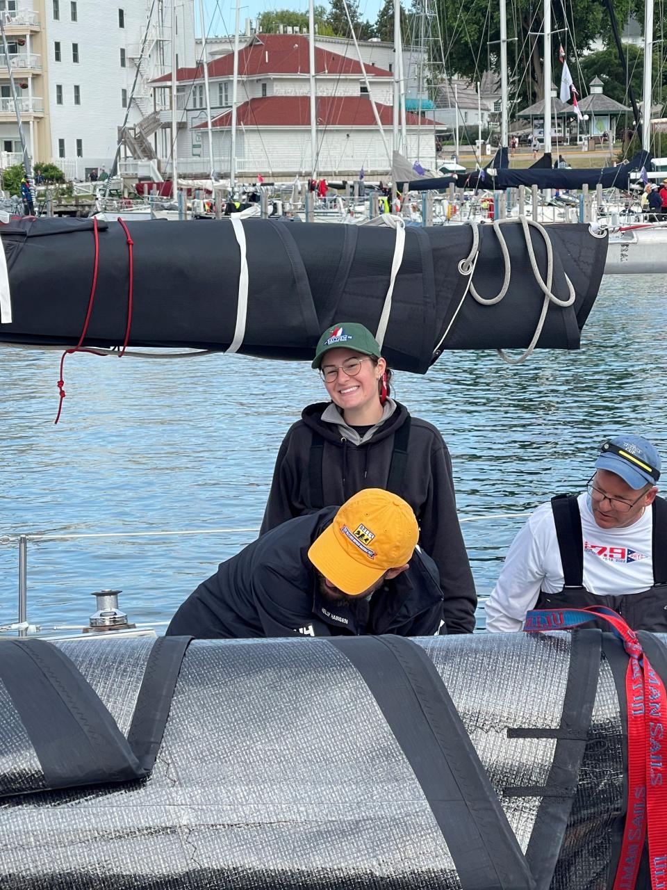 Katie Touma, 19, of Fort Gratiot, is standing on Blue Eyes. Skipper Pat Hoy is on the right, and crewmate Bob Moak Jr., of Sylvan Lake, is in the yellow hat. The boat won second in class and second overall on the Shore Course in the 2023 Bayview Mackinac Race.