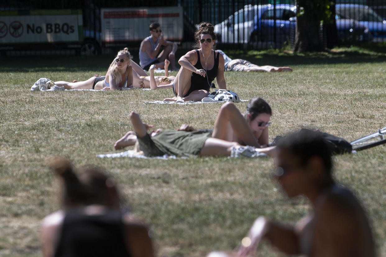 People enjoy the sun in London Fields park in East London as people flock to parks and beaches with lockdown measures eased.