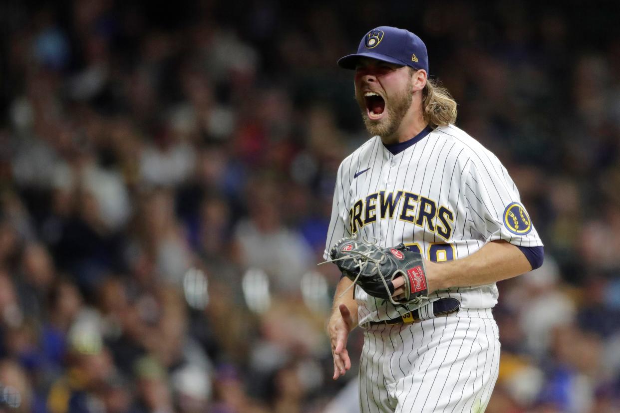 Corbin Burnes reacts after striking out a batter during the seventh inning of a baseball game against the New York Mets Saturday, Sept. 25, 2021, in Milwaukee