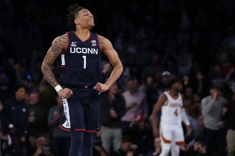 UConn's Solomon Ball (1) celebrates during the second half of an NCAA college basketball game against Texas in the final of the Empire Classic tournament Monday, Nov. 20, 2023, in New York. (AP Photo/Frank Franklin II)
