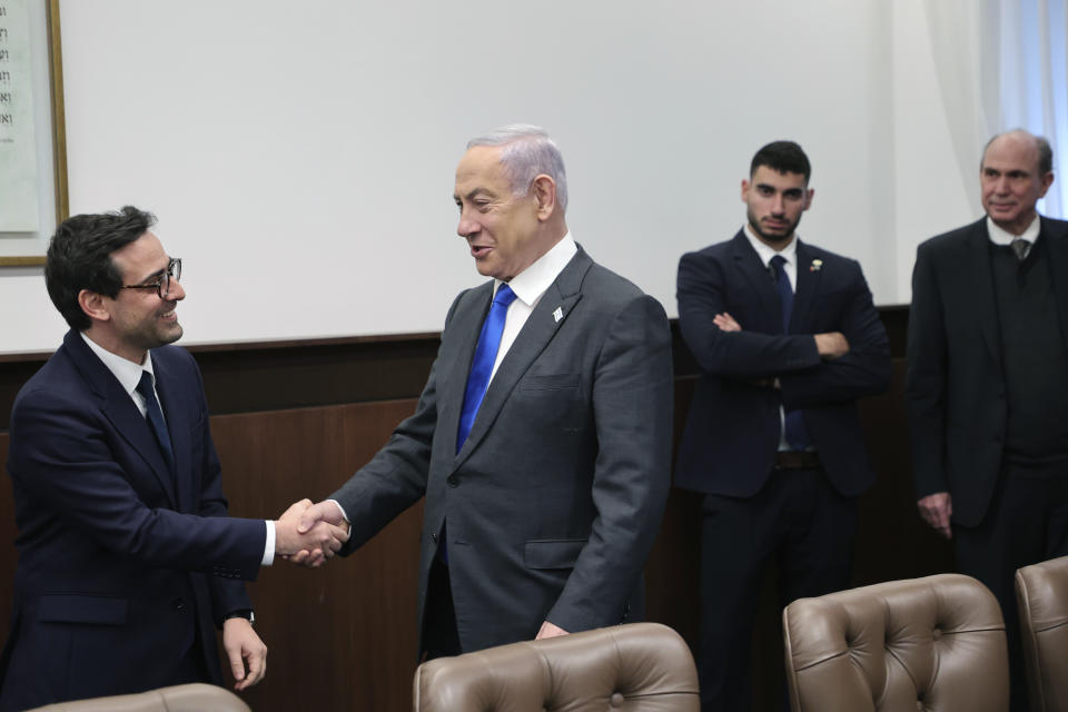 Israeli Prime Minister Benjamin Netanyahu, right, shakes hands with France's Foreign Minister Stephane Sejourne during their meeting in Jerusalem Monday, Feb. 5, 2024. 5, 2024. (Gil Cohen-Magen/Pool via AP)