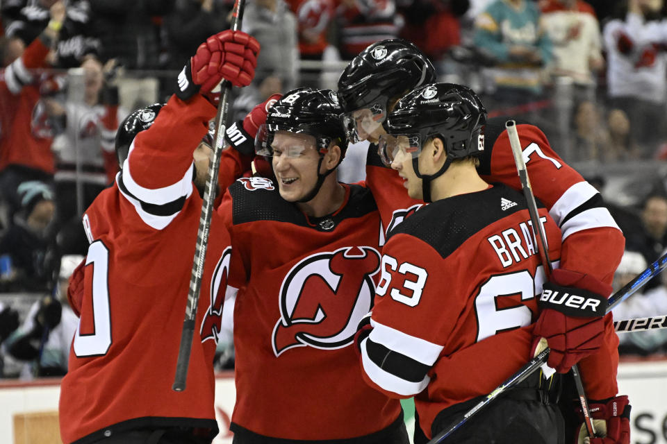 New Jersey Devils defenseman Dougie Hamilton (7) celebrates after his goal with New Tomas Tatar, left, Ondrej Palat (18) and Jesper Bratt (63) during the second period of an NHL hockey game against the Seattle Kraken, Thursday, Feb. 9, 2023, in Newark, N.J. (AP Photo/Bill Kostroun)