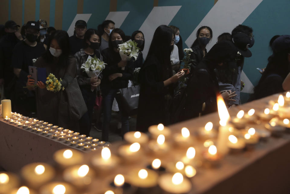 Protesters light candles at the site where student Chow Tsz-Lok fell during a recent protest in Hong Kong on Friday, Nov. 8, 2019. Chow, a Hong Kong university student who fell off a parking garage after police fired tear gas during clashes with anti-government protesters died Friday in a rare fatality after five months of unrest, fueling more outrage against authorities in the semi-autonomous Chinese territory. (AP Photo/Kin Cheung) ///