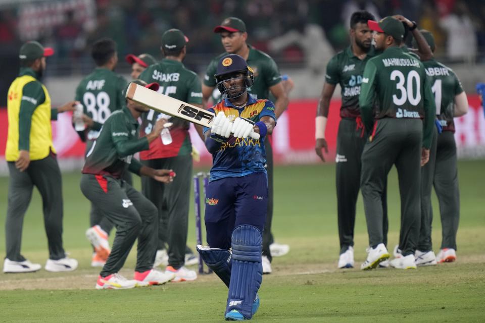 Sri Lanka's Pathum Nissanka, center front, reacts while walks off the field after he losing his wicket during the T20 cricket match of Asia Cup between Bangladesh and Sri Lanka, in Dubai, United Arab Emirates, Thursday, Sept. 1, 2022. (AP Photo/Anjum Naveed)