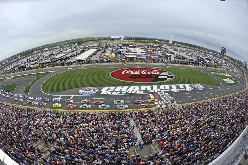 FILE - In this May 27, 2018, file photo, the field takes the green flag to start the NASCAR Cup Series auto race at Charlotte Motor Speedway in Concord, N.C. Some fans have been coming to the Coca-Cola 600 for decades, but they won’t be allowed into Charlotte Motor Speedwaý on Sunday, May 24, 2020, due to Covid-19, leaving the grandstands empty and many disappointed. (AP Photo/Mike McCarn, File)