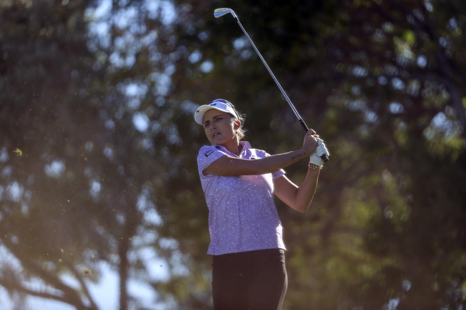 Lexi Thompson follows through with her tee shot on the eighth hole during the first day of the Shriners Children's Open golf tournament, Thursday, Oct. 12, 2023, in Las Vegas. (AP Photo/Ian Maule)