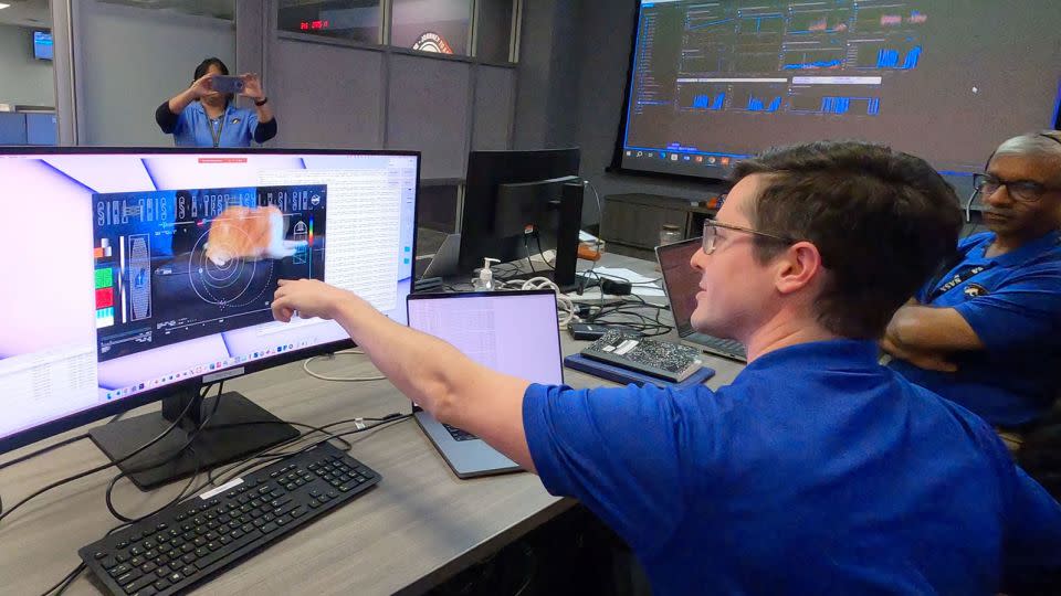 Members of the Deep Space Optical Communications team watch as the first video sent by laser from space reaches computer screens on December 11.  - JPL-Caltech/NASA