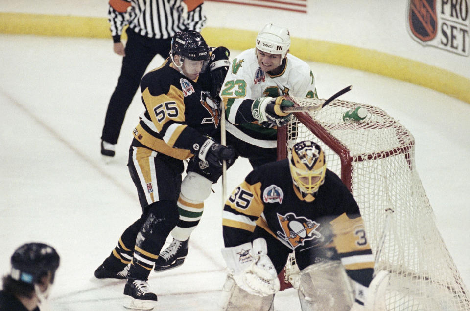 Minnesota North Stars’ Brian Bellows (23) knocks the goal net off its post after he was sent crashing into it by Pittsburgh Penguins’ Larry Murphy (55) as goalie Tom Barrasso guards during first period action of the Stanley Cup Game 6, May 25, 1991 in Bloomington, Minn. (AP Photo/Ann Heisenfelt)