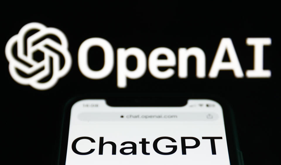 ChatGPT website displayed on a phone screen and OpenAI logo 