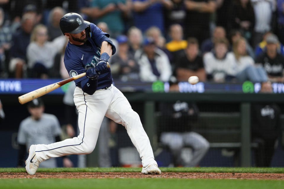 Seattle Mariners' Mitch Haniger hits an RBI single against the Chicago White Sox during the eighth inning of a baseball game, Monday, June 10, 2024, in Seattle. (AP Photo/Lindsey Wasson)