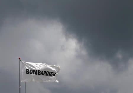 A Bombardier flag flutters amidst storm clouds at the Singapore Airshow at Changi Exhibition Center February 18, 2016. REUTERS/Edgar Su