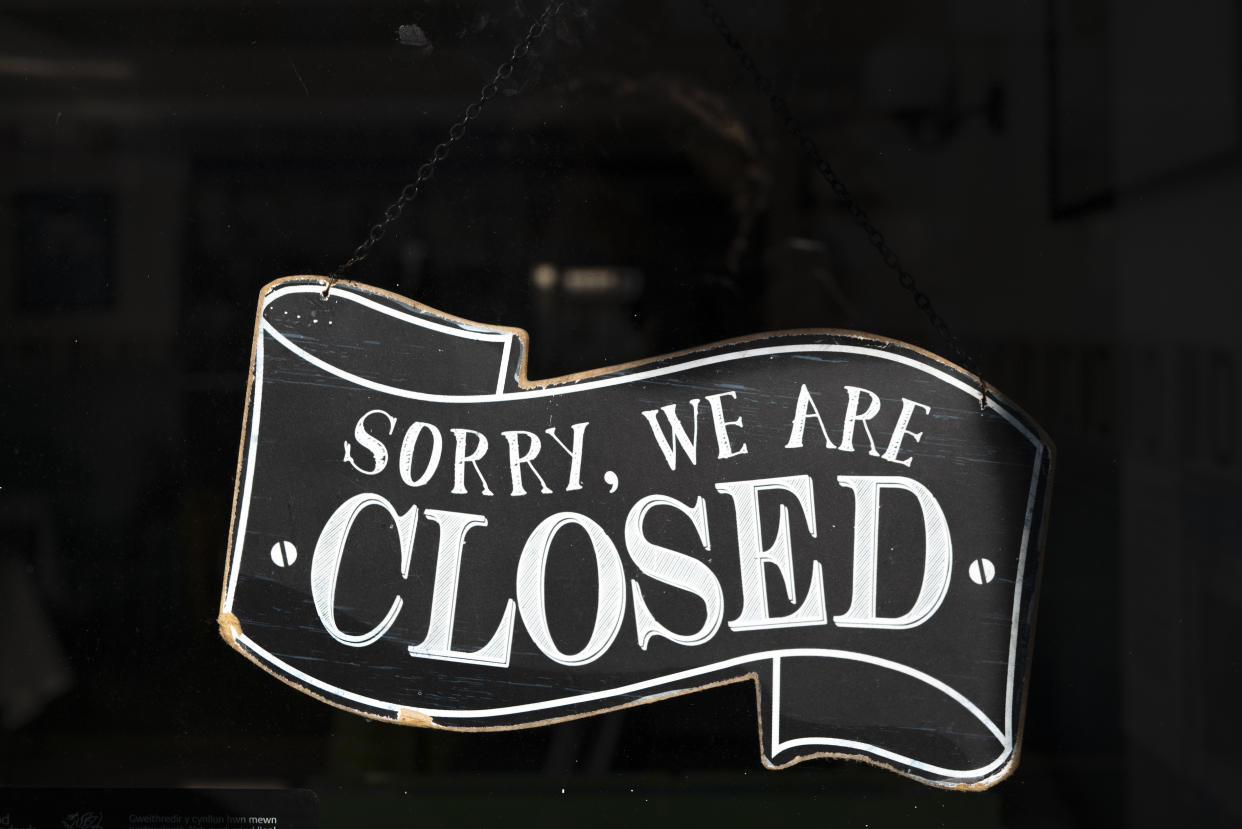 CARDIFF, WALES - FEBRUARY 22: A closed sign in the window of a small business on February 22, 2021 in Cardiff, Wales. Wales First Minister Mark Drakeford has said Wales will remain in lockdown for another three weeks. Primary school children will begin returning to school from February 22 and the Welsh Government has confirmed that it will be reviewing the restrictions around non-essential retail and close contact services as part of its next 21-day review which will end on Friday, March 12. (Photo by Matthew Horwood/Getty Images)