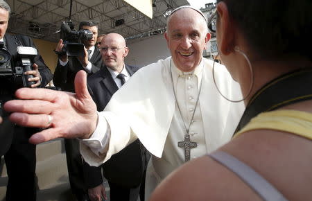 Pope Francis greets a girl as he leads a meeting with young people during his two-day pastoral visit in Turin, Italy, June 21, 2015. REUTERS/Alessandro Garofalo