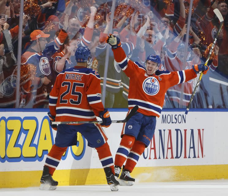 Edmonton Oilers' Darnell Nurse (25) and Connor McDavid (97) celebrate a goal against the San Jose Sharks during the third period of Game 2 of an NHL hockey Stanley Cup first-round playoff series Friday, April 14, 2017, in Edmonton, Alberta. (Jason Franson/The Canadian Press via AP)