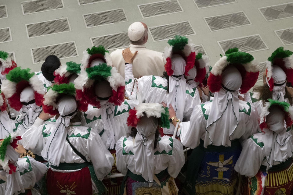 Pope Francis poses for a photo with a group of Mexican pilgrims in the Paul VI Hall at the Vatican during his weekly general audience, Wednesday, Dec. 11, 2019. (AP Photo/Alessandra Tarantino)